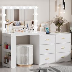 a white vanity with lights on it in a living room next to a couch and chair