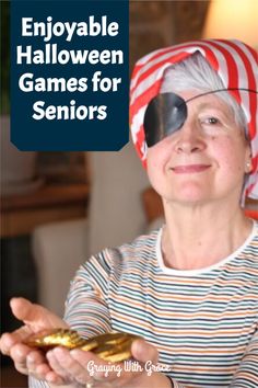 an older woman wearing a red and white striped shirt holding a piece of gold in her hands