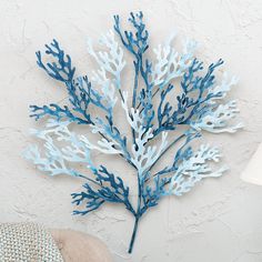 a blue and white seaweed is hanging on the wall