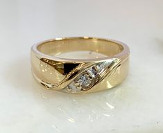 a gold ring with three diamonds on it