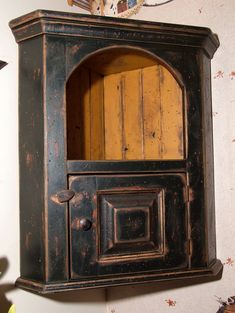 an old fashioned wooden cabinet on the wall