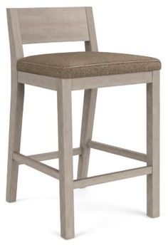 a wooden bar stool with a green cushion on the seat and backrest, against a white background