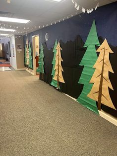 an office hallway decorated with christmas trees and lights