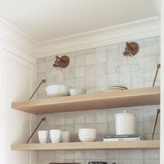 the shelves in the kitchen are filled with dishes