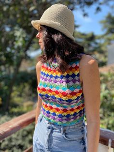 a woman standing on a deck wearing a hat