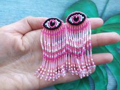 These bead embroidery pink and white color evil eye earrings studs with seed beaded fringe  would make a perfect and unique gift for family, friend, or yourself. ★READY TO SHIP Made with love and care about you!♥ ★DIMENSIONS: 7.5*2.5cm (2.95*0.98 Inches) ★The colors can slightly differ from the photo because of photography lighting and monitor settings. ★ESTIMATED SHIPPING TIMES: North America: 2-4 weeks Europe: 1-3 weeks Australia, New Zealand and Oceania: 3-5 weeks Asia Pacific: 2-4 weeks Latin America and the Caribbean: 3-5 weeks North Africa and the Middle East: 3-5 weeks Sub-Saharan Africa: 3-5 weeks ★PLEASE NOTE: I accept payments through Paypal * you no need to have an account* by credit or debit card. 1. Click Check out with PayPal and you'll be redirected to PayPal. Instead of cho Evil Eye Fringe Earrings, Pink And, Evil Eye Earrings, Handmade Fashion Jewelry, Eye Earrings, Earrings Studs, Linen Bag, Beaded Fringe, Bead Embroidery