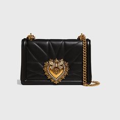 Dolce & Gabbana crossbody bag in quilted lamb leather. Sliding ridged chain shoulder strap. Flap top with hidden snap closure Pearly-beaded sacred heart logo seal. Interior, one zip pocket and metal Devotion heart medallion. Napa leather lining. 5.7"H x 8.3"W x 1.2"D. Made in Italy. Designer Quilted Crossbody Bag, Designer Quilted Satchel Shoulder Bag, Quilted Crossbody Bag, Dolce E Gabbana, Mini Heart, Black Bag, Metallic Logo, Black Cross Body Bag, Dolce & Gabbana