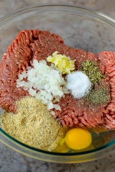 meat, spices and eggs in a glass bowl