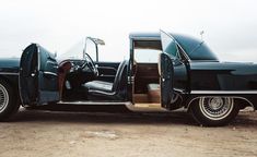 an old black car with the door open