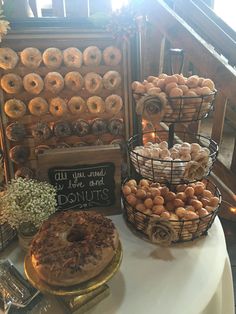 a table topped with lots of donuts next to baskets filled with doughnuts