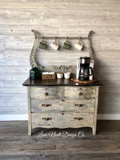 an old dresser has coffee cups on it