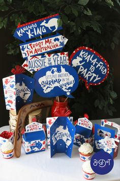 a table topped with cupcakes and patriotic signs