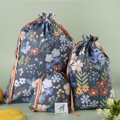 two bags sitting next to each other on top of a table with fruit and vegetables