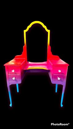 an illuminated vanity with drawers and mirror in the shape of a rainbow - hued dresser