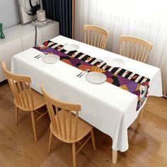 the table is set with two plates and four chairs, along with a place mat