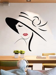 a wall decal with a woman's face wearing a hat