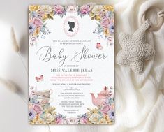 a baby shower is shown on top of a white blanket next to a teddy bear