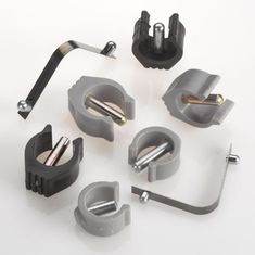 several different types of metal parts on a white surface