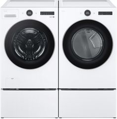 the front load washer and dryer are side by side, both in white