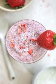 a strawberry and coconut smoothie is garnished with sprinkles