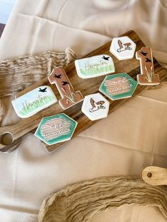 some cookies are laying on top of a wooden tray with scissors and other items around them