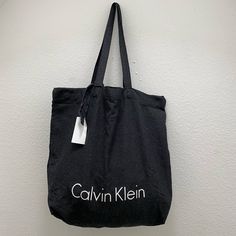 Black Calvin Klein Tote Bag, Light Weight Large Capacity Black Canvas Pouch Bag, Casual Black Canvas Bag, Trendy Black Canvas Bag With Removable Pouch, Black Canvas Pouch Bag With Adjustable Strap, Chic Black Canvas Bag With Removable Pouch, Modern Black Canvas Bag With Large Capacity, Chic Black Canvas Bag With Adjustable Strap, Black Canvas Pouch Bag For Shopping, Black Canvas Travel Pouch Bag