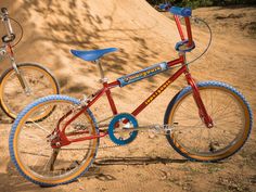 two bikes parked next to each other in the dirt