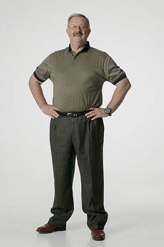 an older man standing with his hands on his hips