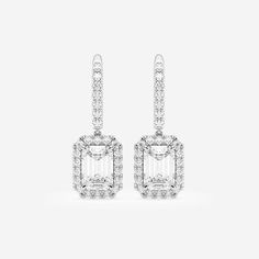 Let these emerald cut diamond earrings drop from your ears and scream out style. Each lab grown emerald shaped diamond is surrounded by round stones t Emerald Cut Diamond Earrings With Halo Design, Emerald Cut Halo Diamond Earrings, Diamond Emerald-cut Halo Earrings, White Diamond Emerald Cut Earrings, White Diamond Earrings With Emerald Cut, White Emerald Cut Cubic Zirconia Earrings, White Emerald-cut Cubic Zirconia Earrings, White Emerald Cut Earrings With Diamond Accents, White Emerald Cut Baguette Diamond Earrings