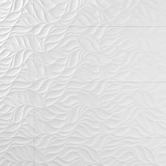 a white tile wall with wavy lines on it