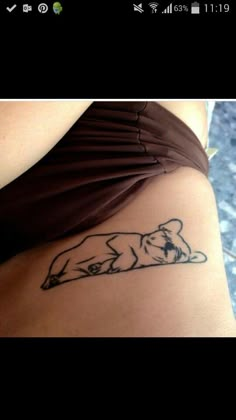 a woman's stomach with a dog tattoo on her left side ribcage