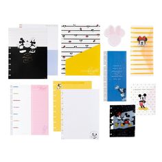 the mickey mouse notebooks are lined up in different colors and designs, including black, yellow, pink, blue, and white