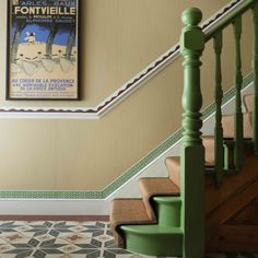 the stairs in this house have been painted green and beige with white trimmings