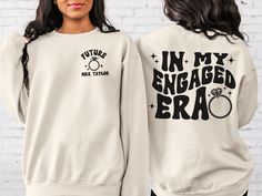 two women wearing sweatshirts with the words in my engaged era printed on them,