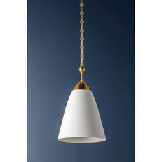 a white and gold pendant light hanging from a chain on a dark blue wall background