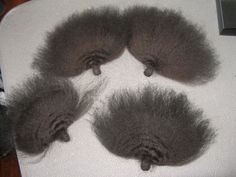 four gray furry animals laying on top of a white blanket with caption below that reads, according to the grooming process, the poopies appear to be