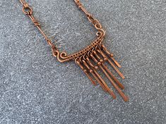 This artisan copper necklace features a handmade pendant with hammered copper dangles, intricate wire wrapping, and spiral motifs. Inspired by ancient jewelry from Mesoamerica, this rustic necklace makes a beautiful statement piece made from high-quality pure copper. 📐 SIZING:  Total length around is 22 inches. Pendant height is 3 inches, width is 3 inches. ✨ MATERIALS: Every item is 100% handmade and one-of-a-kind. The wire-wrapped copper jewelry is oxidized and polished to beautifully highlig Rustic Necklace, Rectangle Necklace, Chainmail Jewelry, Wire Work Jewelry, Handmade Wire Jewelry, Ancient Jewelry, Work Jewelry, Copper Pendant, Wire Wrapped Necklace