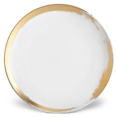 a white and gold plate on a white background