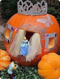 a pumpkin decorated with princesses and other decorations