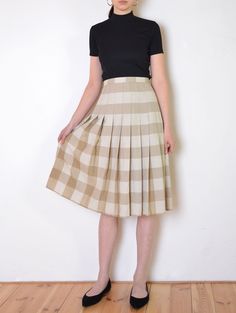 Cool vintage skirt made of gently textured, matte fabric - woven with plaid pattern in tones of beige and white. Flared, a line midi fit. Button and zip closure on the back. Unlined. The item has been pinned on the model Era: 70's Fabric: not given, feels like cotton to touch Condition: very good Estimated size: L / XL (please, check the measurements) Measurements (measured flat, need to be doubled to get the circumference): Waist: 45 cm / 17,7 inches Length: 72 cm / 28,3 inches Beige A-line Pleated Skirt For Fall, Summer Plaid Pleated Skirt, Fall Cotton Midi Pleated Skirt, Fall Cotton Pleated Midi Skirt, Cream Pleated Skirt For Fall, Cream Midi Skirt For Fall, Fitted Beige Pleated Skirt With Accordion Pleats, Fitted Beige Accordion Pleats Skirt, Fitted Cream Flared Pleated Skirt