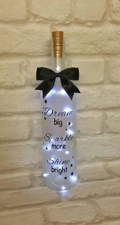 a light up bottle with a bow on it that says dream big x sorry more shine bright