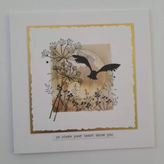 a card with an image of a bird flying over plants