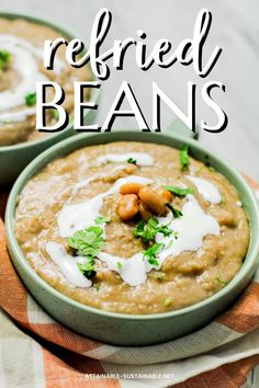 two bowls filled with refried beans and garnished with parsley on top