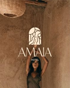 a woman standing in front of a wall with the word amaja above her head