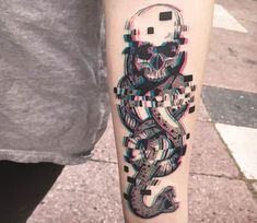 a person with a tattoo on their arm that has an image of a snake in it