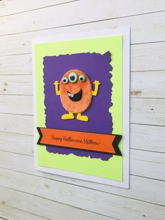 a halloween card with an orange monster on it