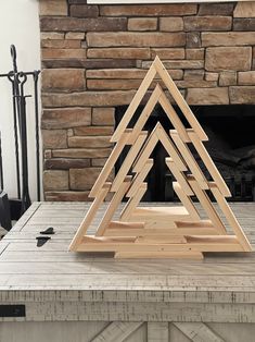 a wooden christmas tree sitting on top of a table