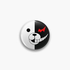 a black and white button with a red nose