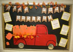 a bulletin board decorated with fall leaves and an orange truck