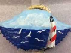 a cake shaped like a lighthouse with seagulls around it